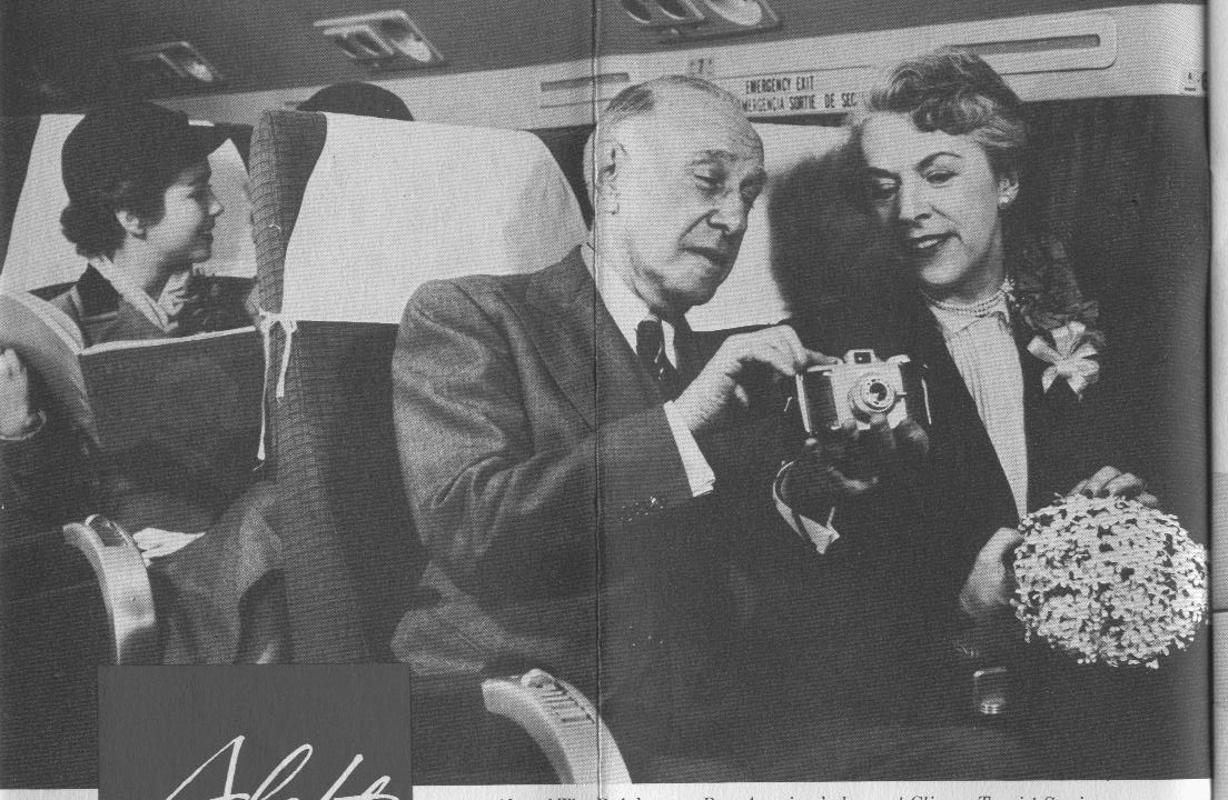 1950s A couple enjoy a happy moment in economy seats aboard a Pan Am Clipper.
